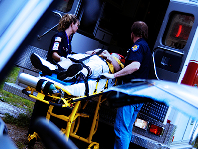 A person being taken to the hospital in an ambulance.