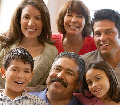 A large Hispanic family smiling