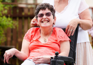 disabled woman with carer in garden