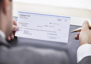 Businessman Filling Cheque