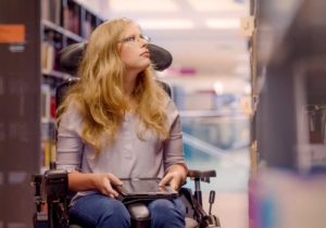 woman in wheelchair in library 