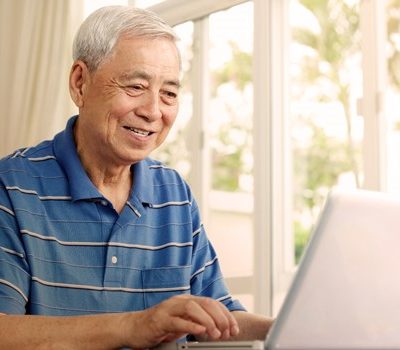 An elderly man on laptop