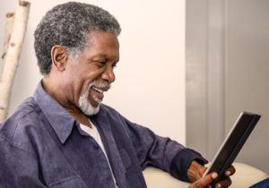 man smiling and looking at laptop 