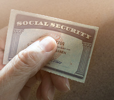 A hand holding a Social Security Card