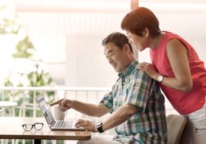 man and woman looking at laptop 