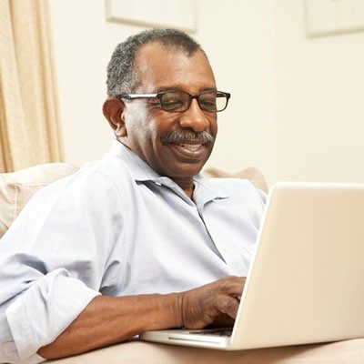 man searching internet on laptop computer