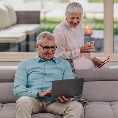 older couple reviewing information a laptop computer