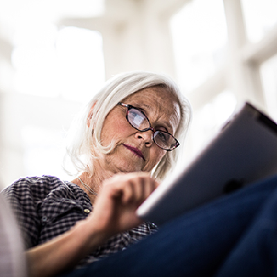 older woman reviewing information on a tablet