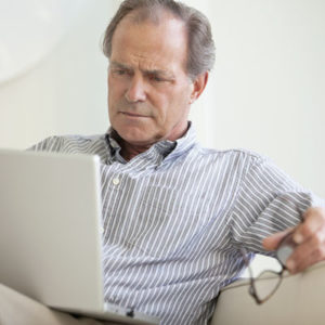 Serious man using laptop
