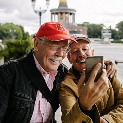 Two older men video chatting on a smartphone