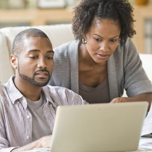 Couple reviewing financial information on a laptop
