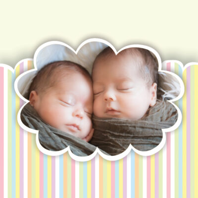 Two babies sleeping beside each other.